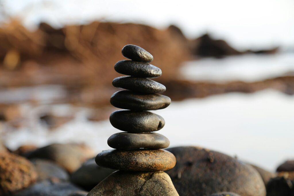 pexels photo 355863 355863 A stack of smooth stones artfully balanced by a waterside, evoking tranquility and zen.